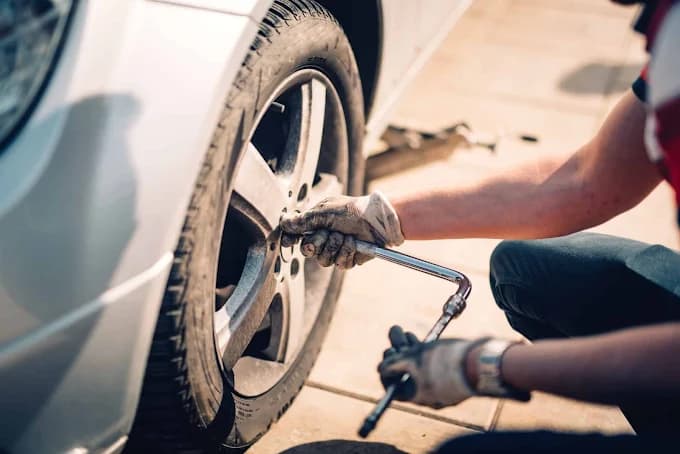 Mechanic changing a car tyre